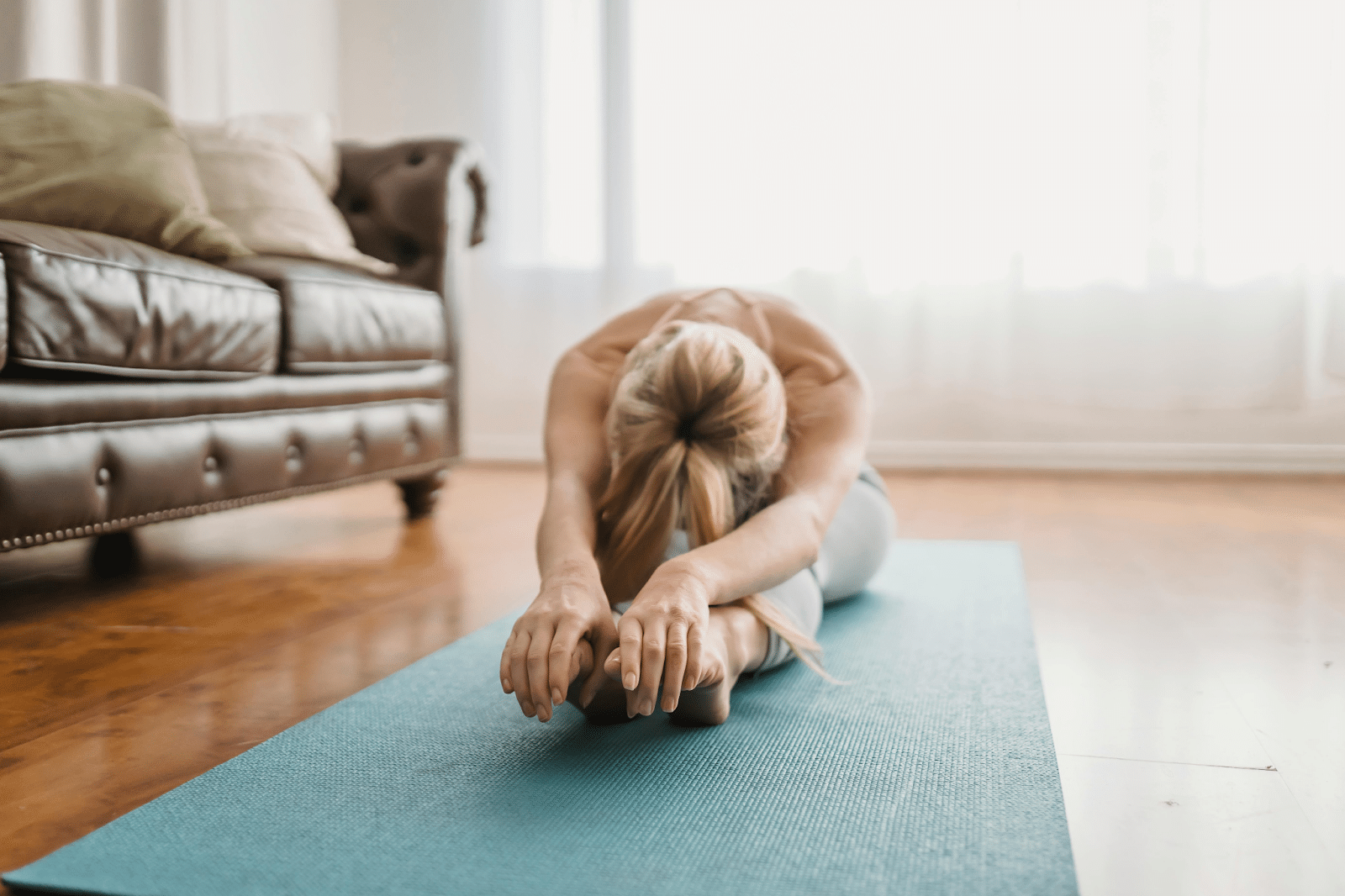 Person performing stretching exercises to reduce risk of bulging disk